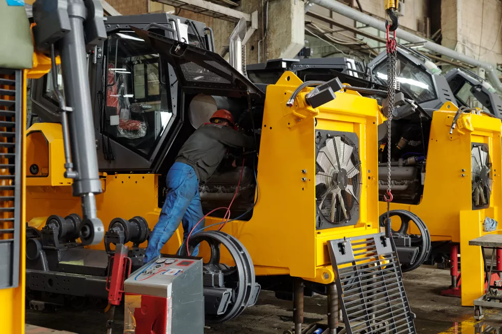 engineer-modern-industrial-construction-plant-examining-motor-machine