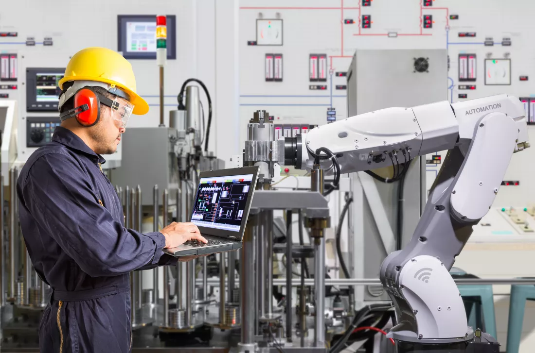 engineer-using-laptop-computer-maintenance-automatic-robotic-hand-machine-tool-automotive-industry