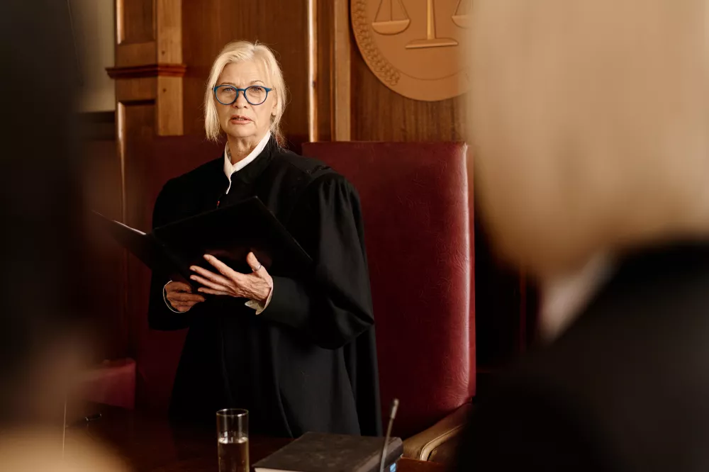 confident-female-judge-eyeglasses-black-mantle-announcing-verdict