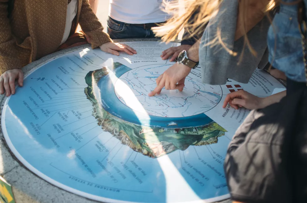 friends-pointing-towards-map