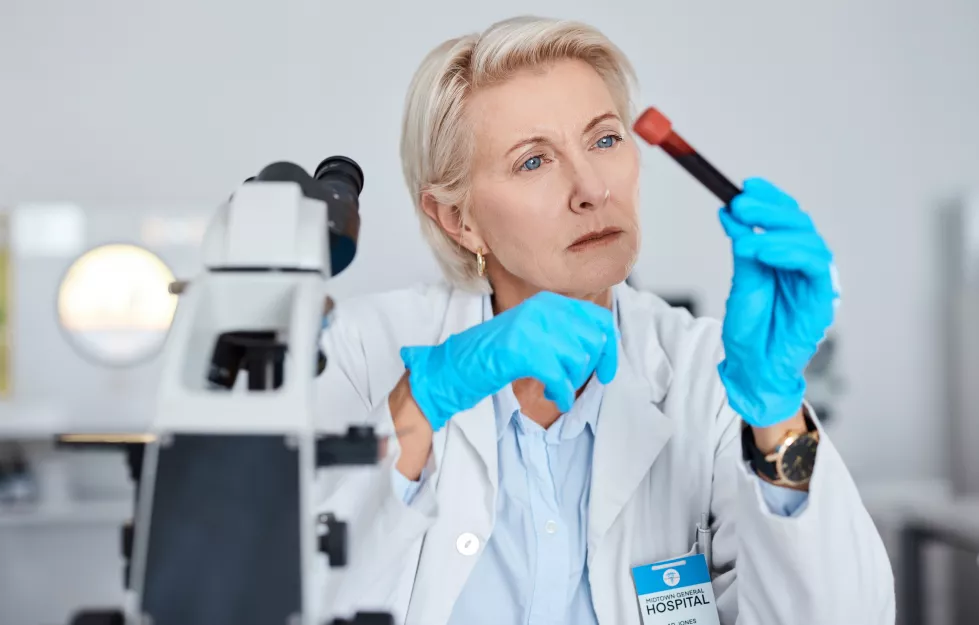senior-woman-doctor-hands-with-blood-sample-vial-tube-scientific-research-testing-exam-lab-elderly-female-scientist-medical-expert-holding-dna-science-test-laboratory