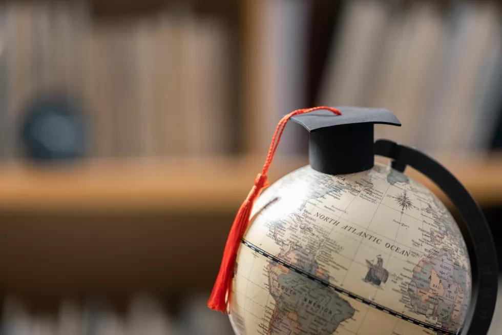 graduation-cap-with-earth-globe-concept-global-business-study-abroad-educational-back-school-education-global-world-study-abroad-business-universities-worldwide-language-study(1)