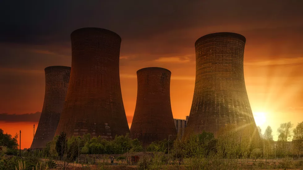 green-grass-field-near-power-plant-sunset