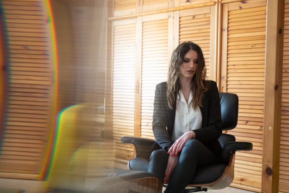 young-woman-sitting-chair-corridor