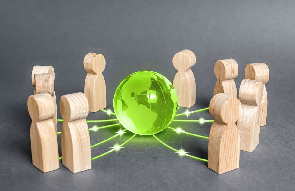 people-surrounded-green-globe-planet-earth-cooperation-collaboration-people(1)