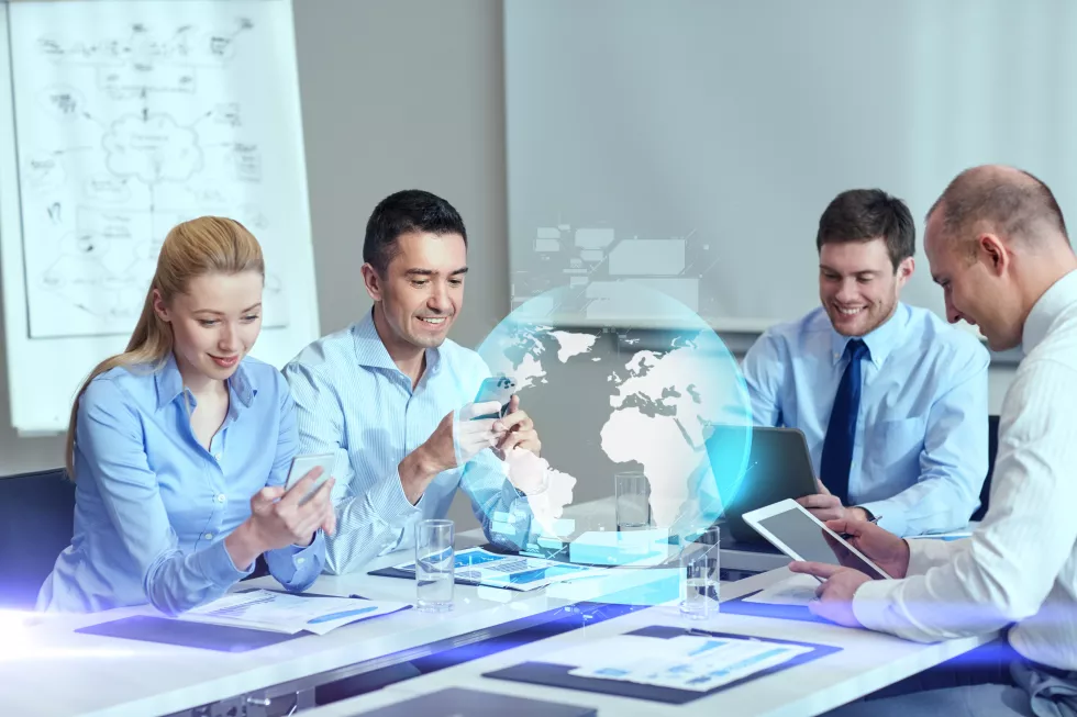 business-people-cooperation-technology-concept-smiling-business-team-with-gadgets-globe-hologram-meeting-office(2)