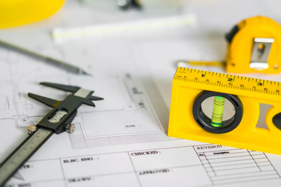 construction-plans-with-helmet-drawing-tools-blueprints