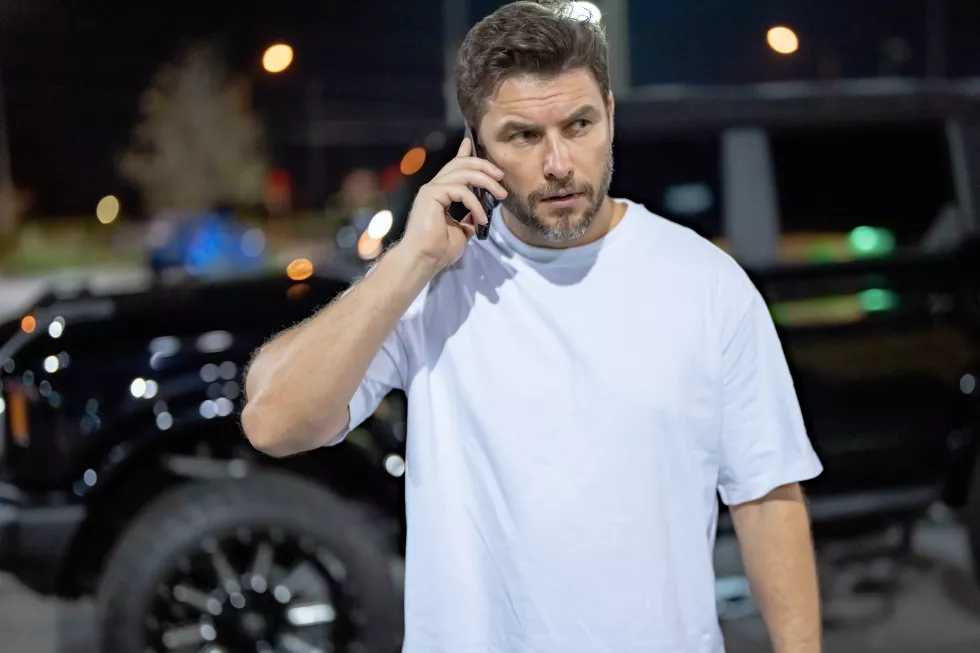 gangster-criminal-concept-angry-man-near-car-night-urban-street-dangerous-aggressive-man-with-ser