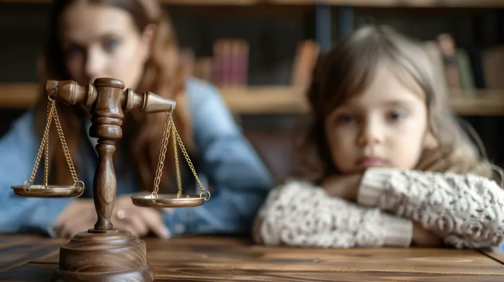 cute-child-mother-table-with-gavel-judge-blurred-background-family-law-concept