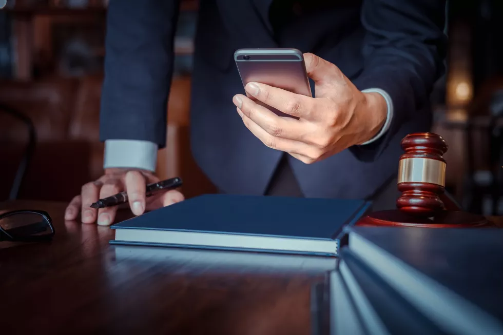 midsection-man-using-mobile-phone-table
