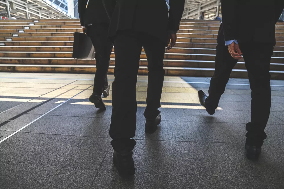 low-section-businessmen-walking-towards-steps