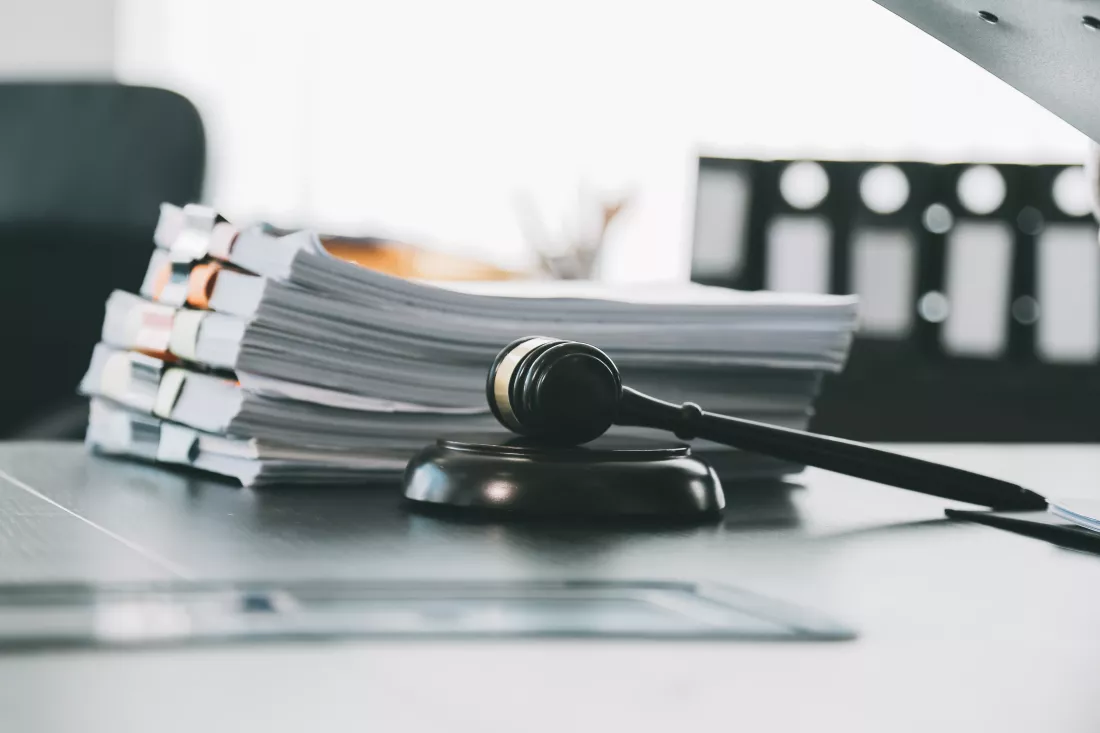 business-lawyers-discussing-contract-papers-with-brass-scale-desk-office-law-legal-services-advice-justice-law-concept-picture-with-film-grain-effect