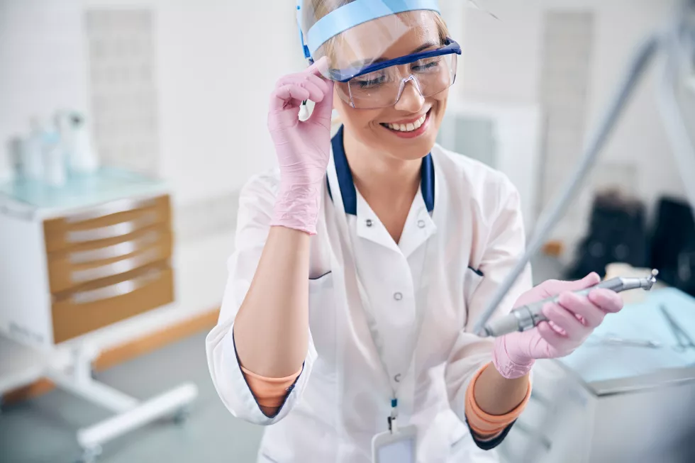 happy-young-dentist-working-with-digital-equipment