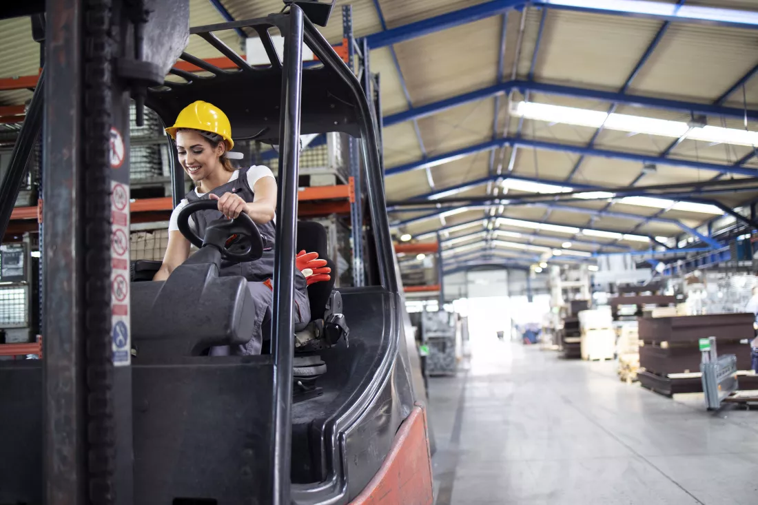 professional-female-industrial-driver-operating-forklift-machine-factory-s-warehouse