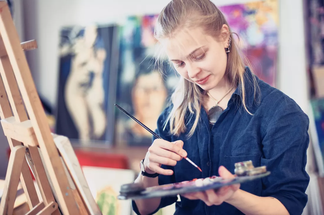 young-woman-artist-working-painting-studio