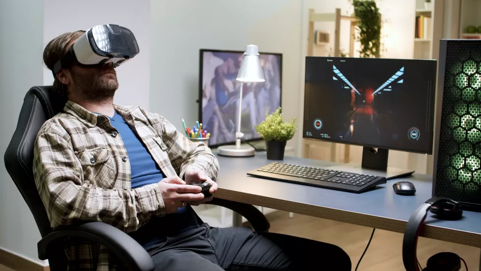 bearded-man-sitting-gaming-chair-playing-games-using-vr-headset-woman-background