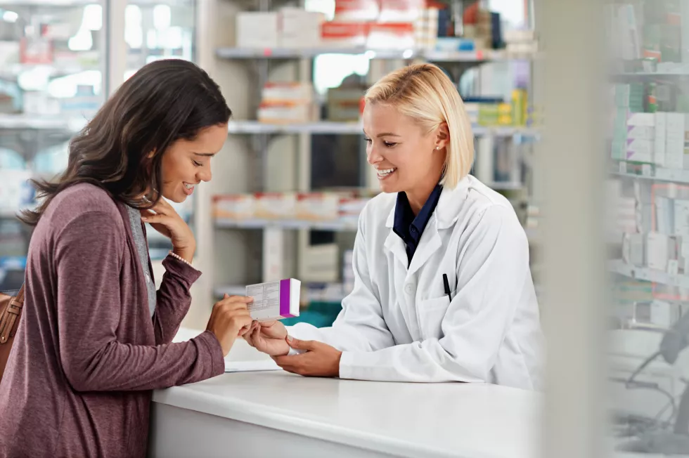 happy-customer-pharmacist-with-healthcare-medicine-assistance-help-expertise-store-counter-advice-opinion-worker-helping-girl-with-medication-information-pharmacy