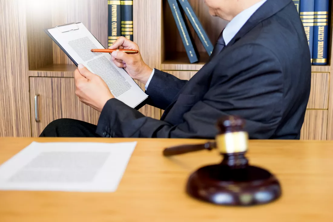 midsection-lawyer-reading-paper-courthouse