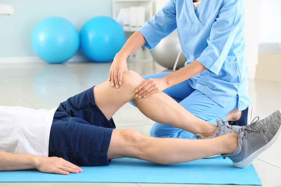 physiotherapist-working-with-male-patient-rehabilitation-center