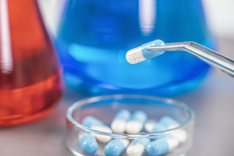 scientist-holding-medicine-with-pincers-petri-dish