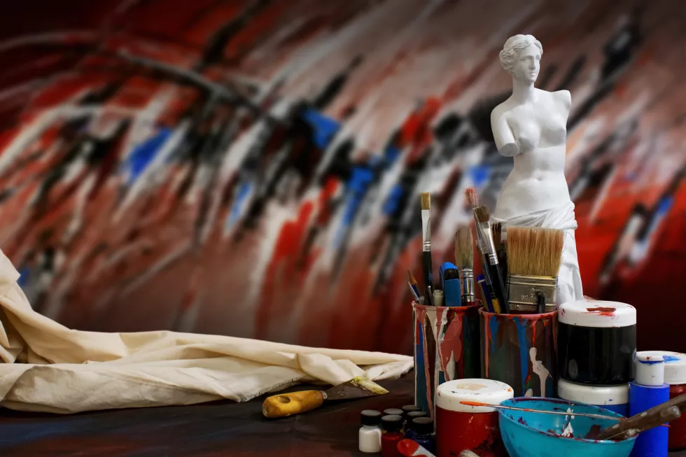 set-paintbrushes-colored-painted-cup-front-venus-statue