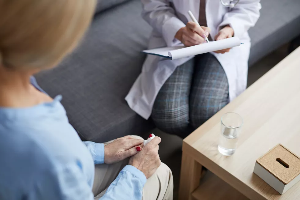unrecognizable-female-doctor-writing-clipboard-consultation