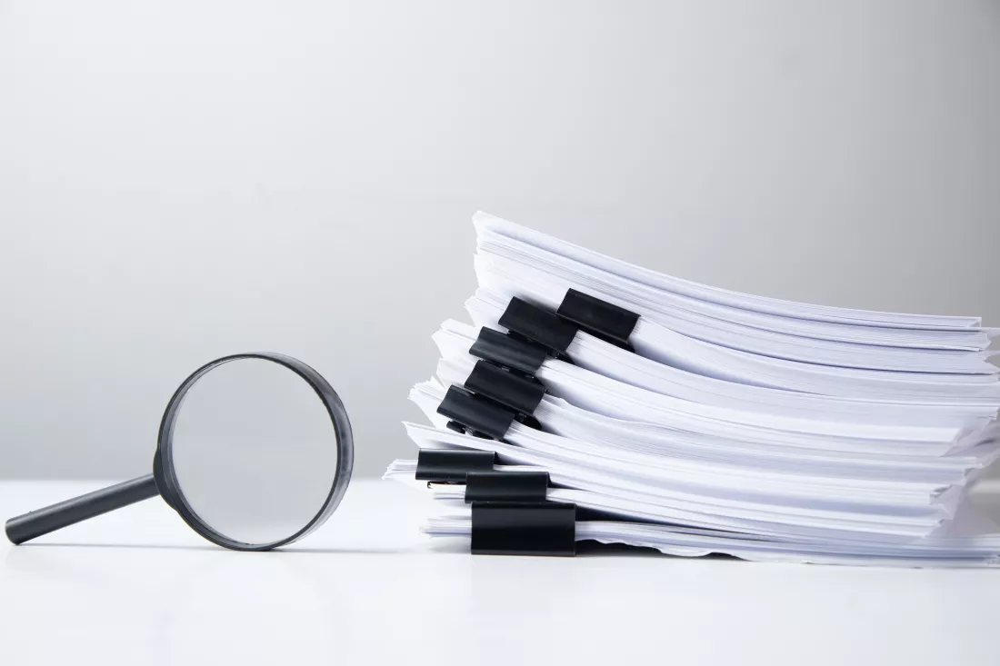 stack-report-paper-documents-with-magnifying-glass-concept-business-search