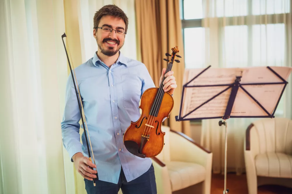 man-playing-violin-home-he-is-practicing-live-performance