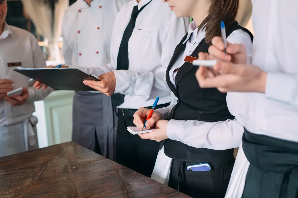restaurant-manager-his-staff-terrace-interacting-head-chef-restaurant