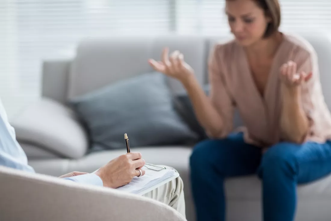 therapist-making-notes-patient