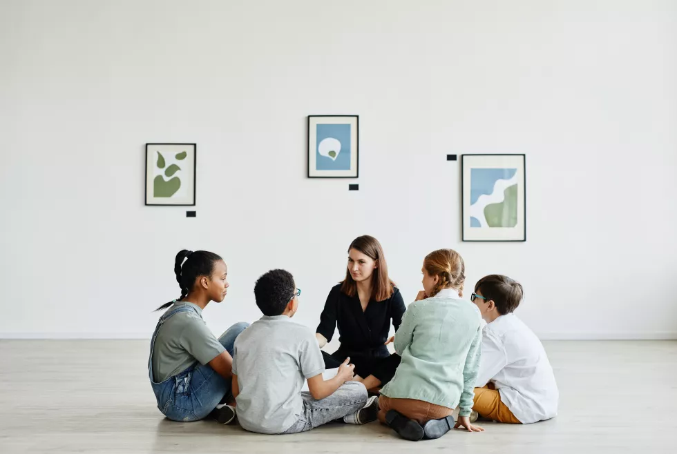 full-length-view-diverse-group-children-sitting-circle-class-art-gallery-copy-space