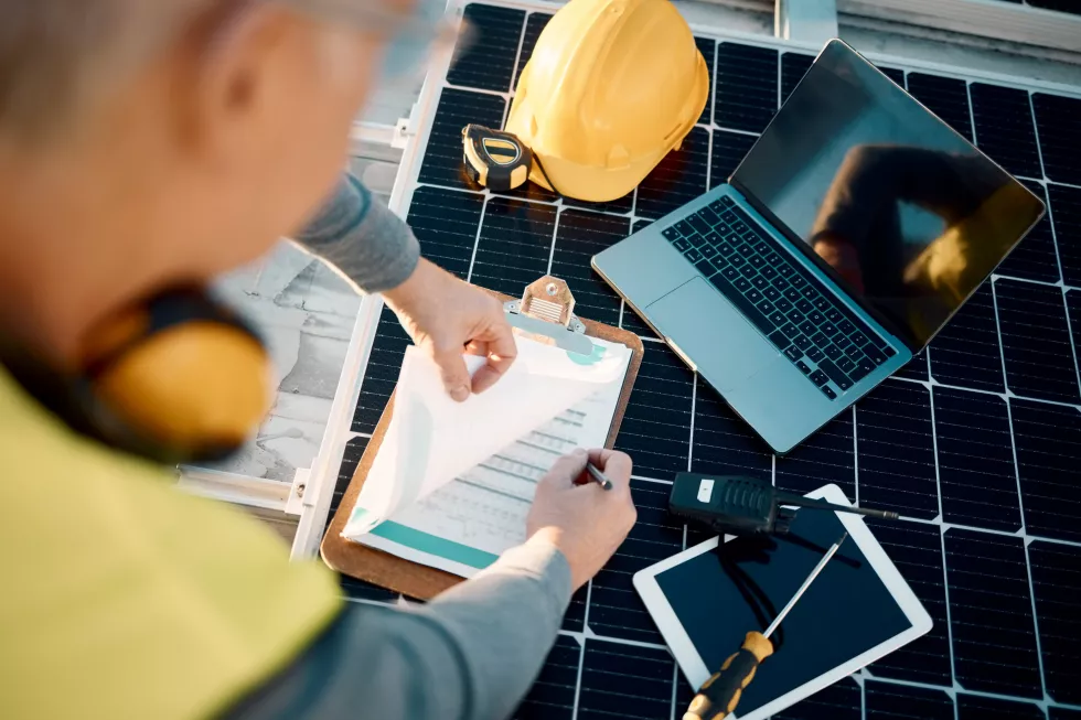 solar-panels-planning-engineering-hands-with-technology-checklist-insurance-installation-energy-saving-electricity-power-technician-with-laptop-tools-maintenance-management