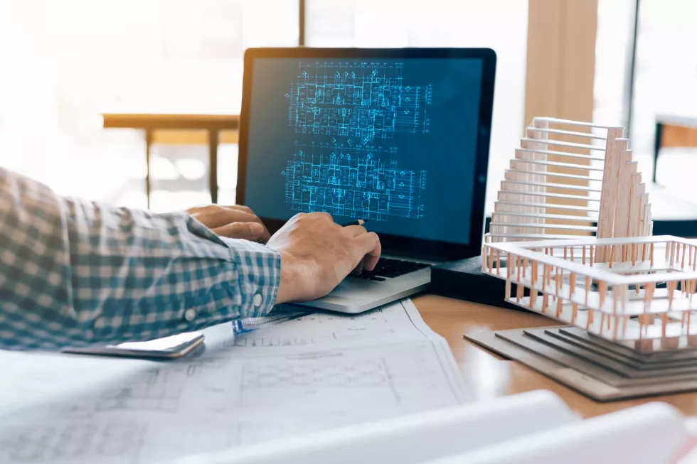 cropped-hands-man-using-laptop-table