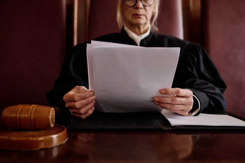 hands-mature-female-impartial-judge-holding-juridical-documents-describing-decision-court