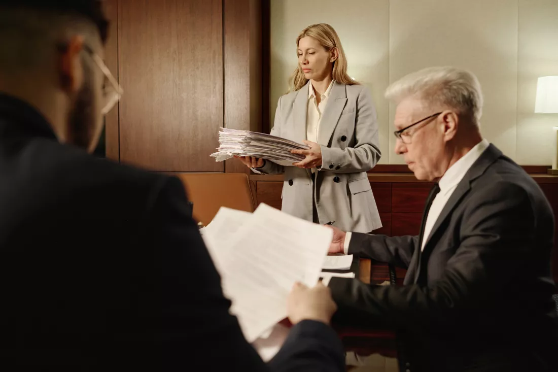 female-attorney-her-male-colleagues-working-with-documents