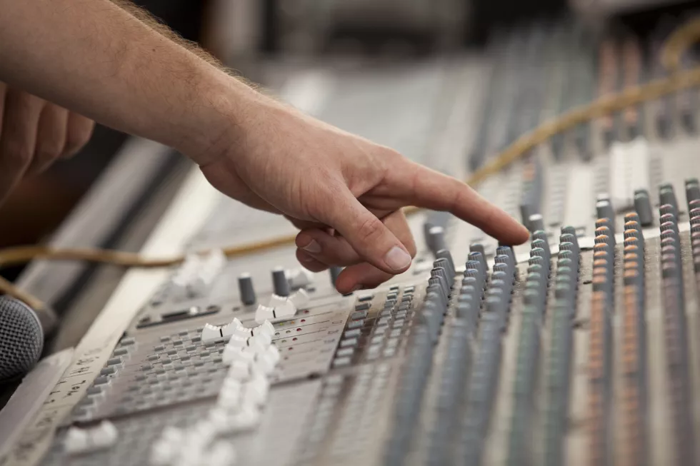 close-up-hand-using-sound-mixer