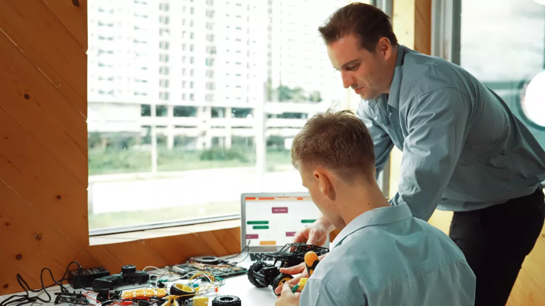 teacher-help-student-fixing-car-model-giving-advise-class-edification
