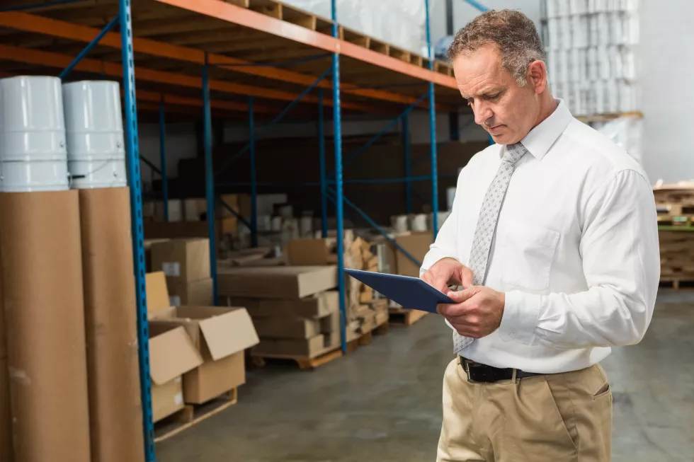 smiling-warehouse-manager-using-tablet-pc