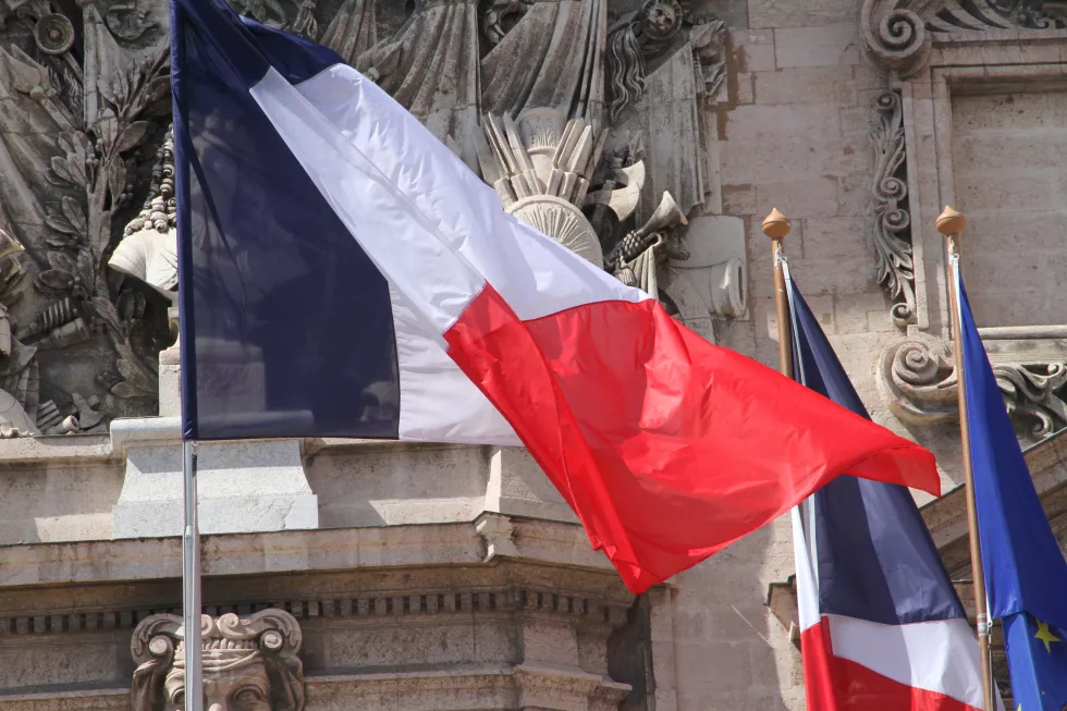 low-angle-view-flags-against-historical-building