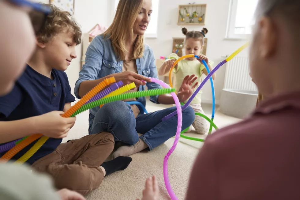 teacher-children-doing-sensory-exercises-with-pipes