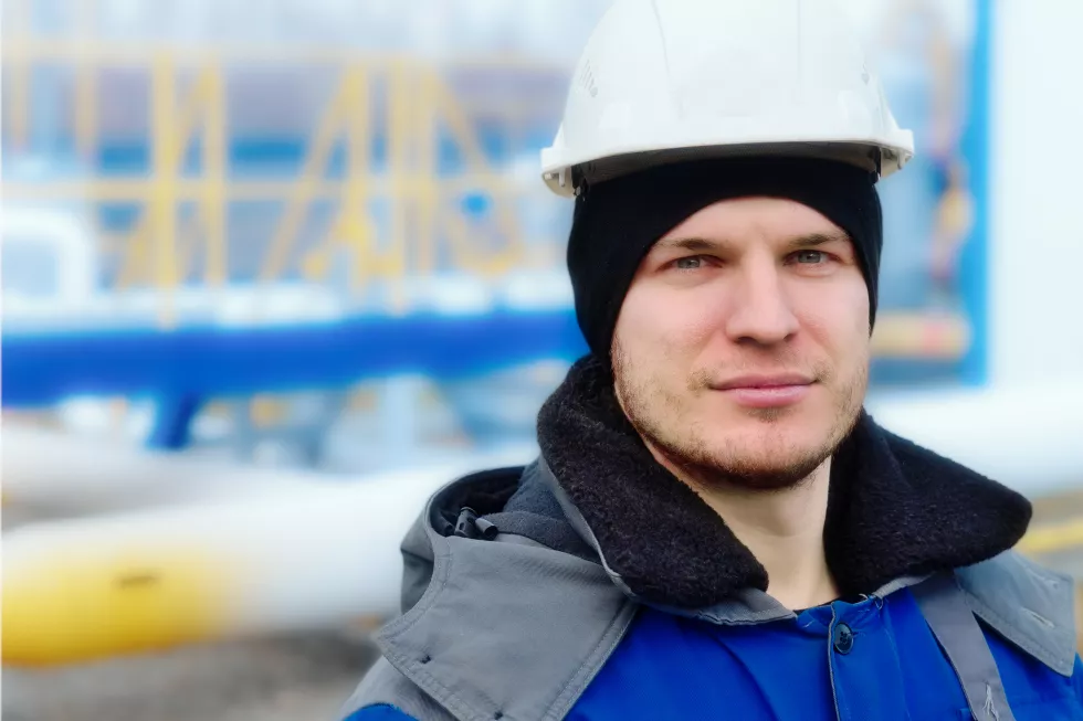 closeup-portrait-caucasian-engineer-builder-white-hard-hat-winter-pea-jacket-middleaged-worker-looks-into-camera-with-confident-look