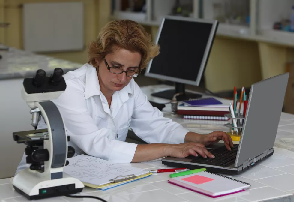 scientist-working-laptop-table