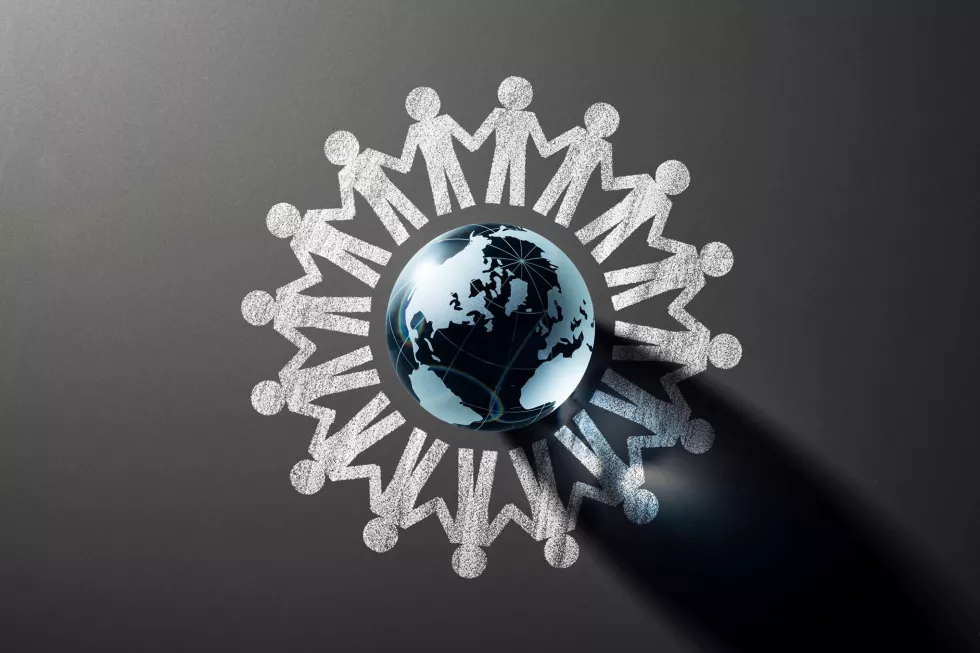 human-chain-around-glass-globe-blackboard