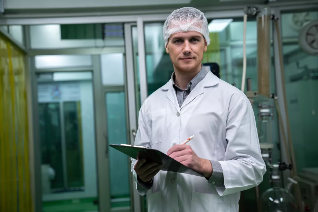 apothecary-scientist-recording-data-from-cbd-oil-extractor-laboratory