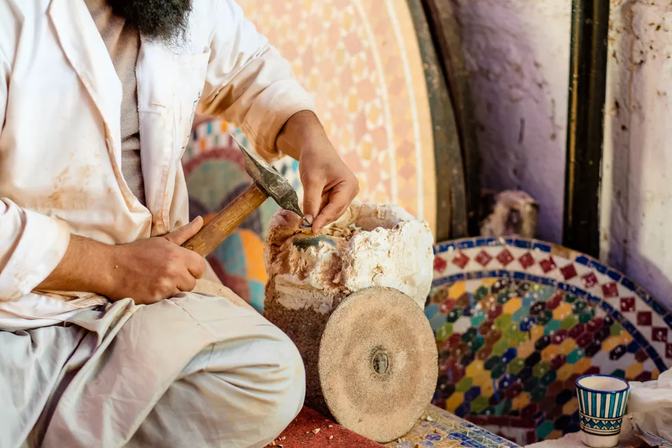 midsection-man-carving-wood-workshop