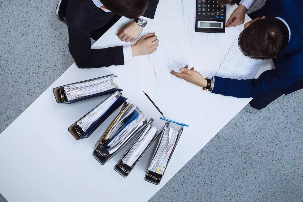 business-people-meeting-view-from-bookkeeper-financial-inspector-making-report-calculating-checking-balance-internal-revenue-service-checking-financial-document-audit-tax-conce(1)