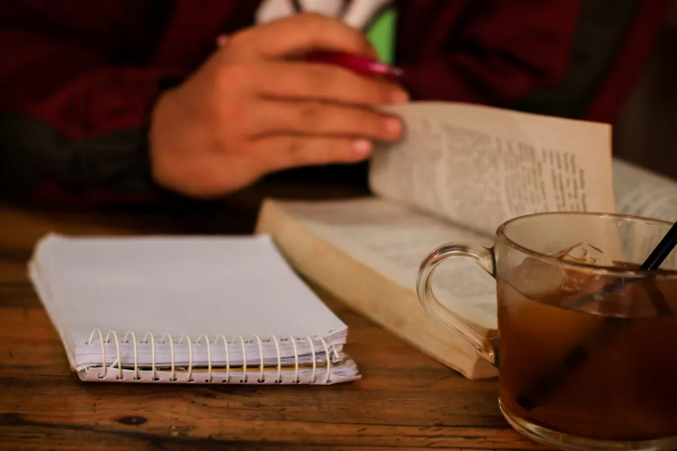 midsection-man-reading-book-table(1)