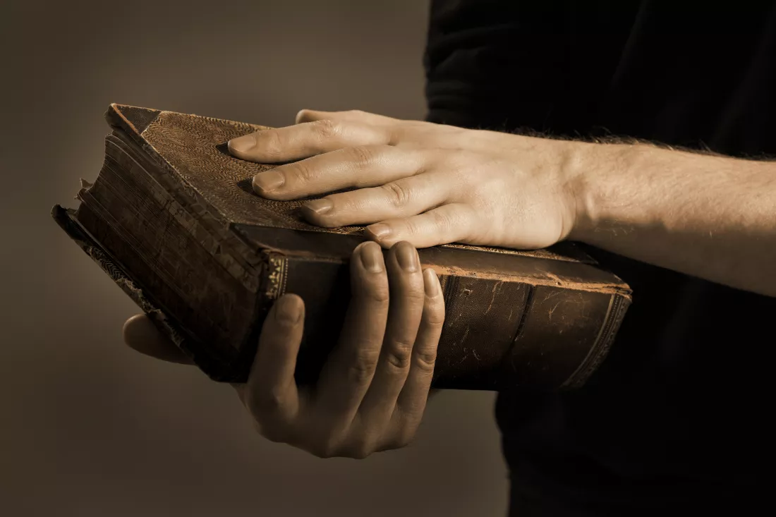 close-up-midsection-hand-holding-bible