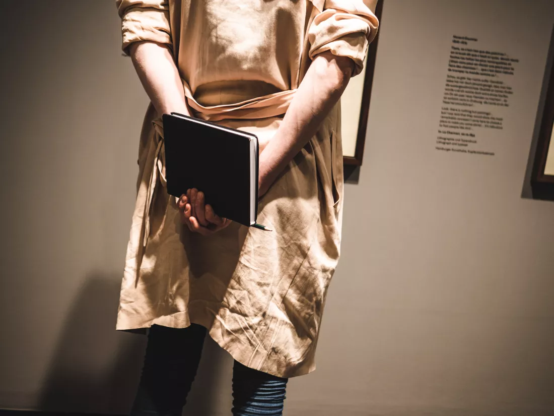 rear-view-man-holding-book-museum