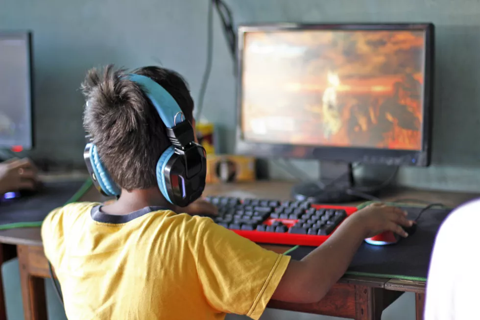 rear-view-boy-playing-computer